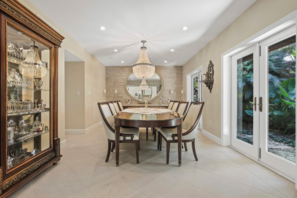 Photo of a transitional separate dining room in Miami with beige walls and white floor.