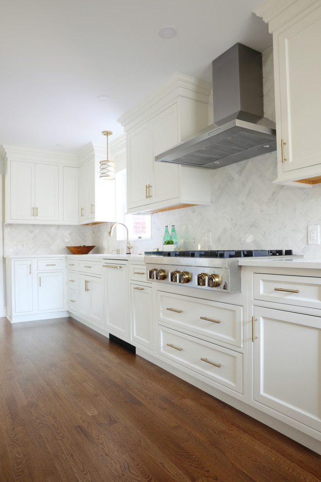 Design ideas for a mid-sized transitional l-shaped kitchen in New York with an undermount sink, beaded inset cabinets, white cabinets, quartz benchtops, white splashback, marble splashback, stainless steel appliances, dark hardwood floors and white benchtop.