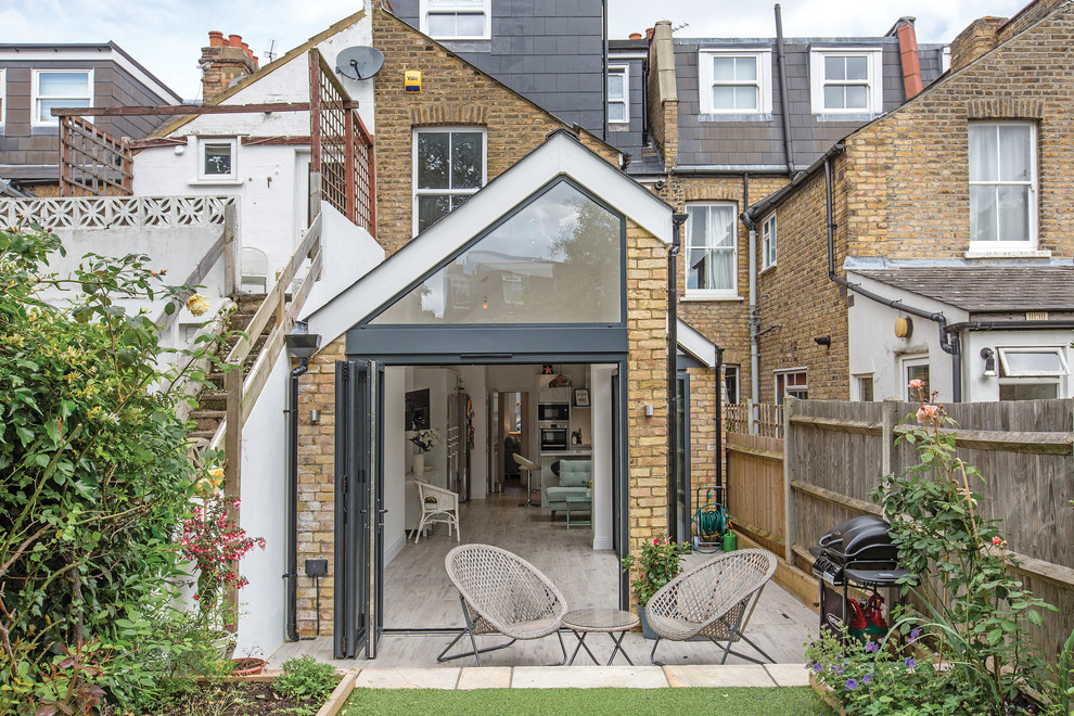 Inspiration for a small country backyard patio in London with concrete slab and no cover.