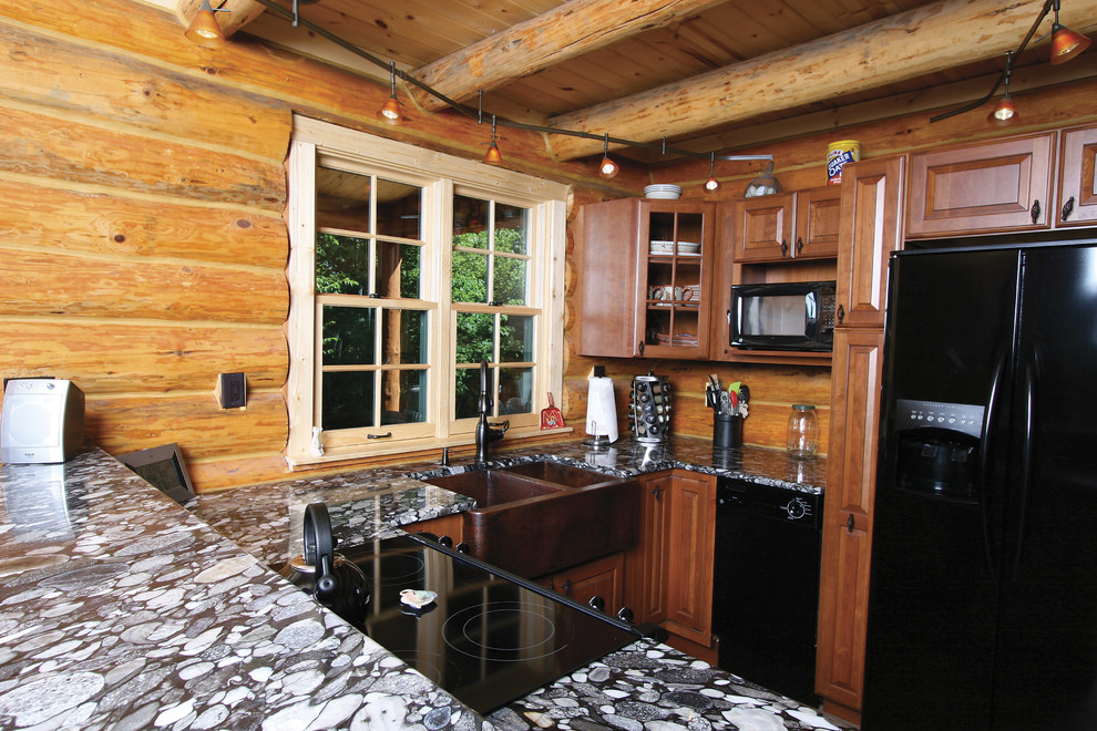 Inspiration for a small rustic u-shaped kitchen remodel with a farmhouse sink, raised-panel cabinets, medium tone wood cabinets, granite countertops, brown backsplash, wood backsplash, black appliances and a peninsula