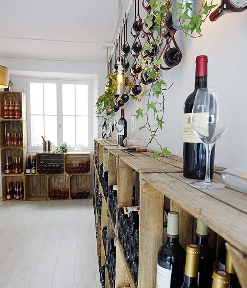 Design ideas for a mid-sized traditional wine cellar in Nantes with laminate floors, storage racks and grey floor.