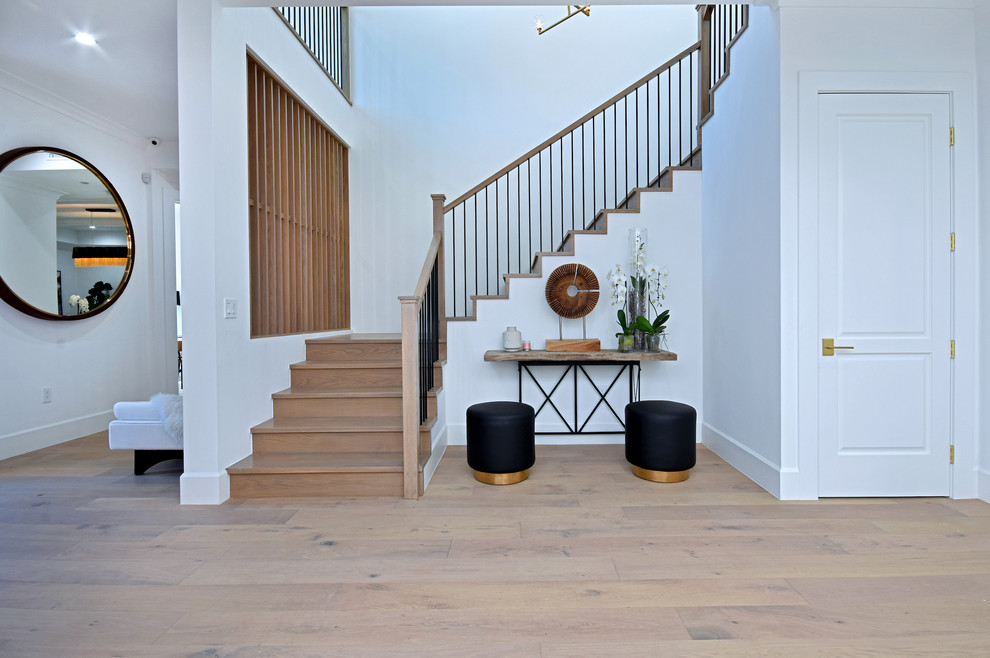 Design ideas for a transitional wood u-shaped staircase in Los Angeles with wood risers and mixed railing.