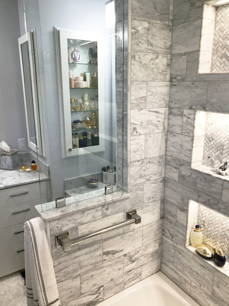Photo of a large contemporary master bathroom in Houston with shaker cabinets, white cabinets, a drop-in tub, a shower/bathtub combo, marble, grey walls, slate floors, an integrated sink, marble benchtops, grey floor and an open shower.