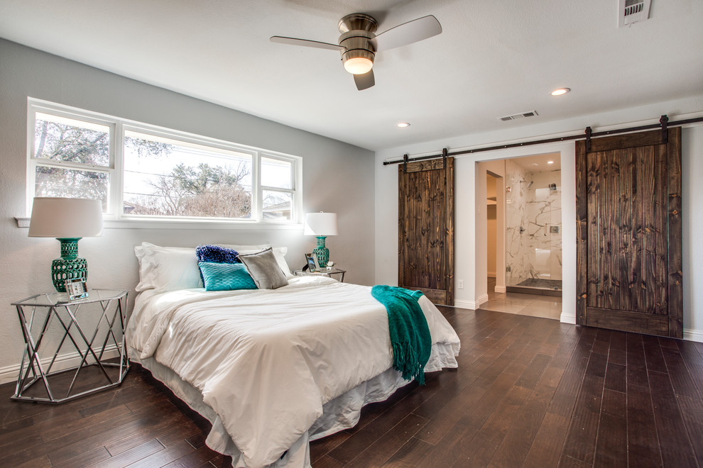 Large transitional master bedroom in Dallas with grey walls, dark hardwood floors and brown floor.