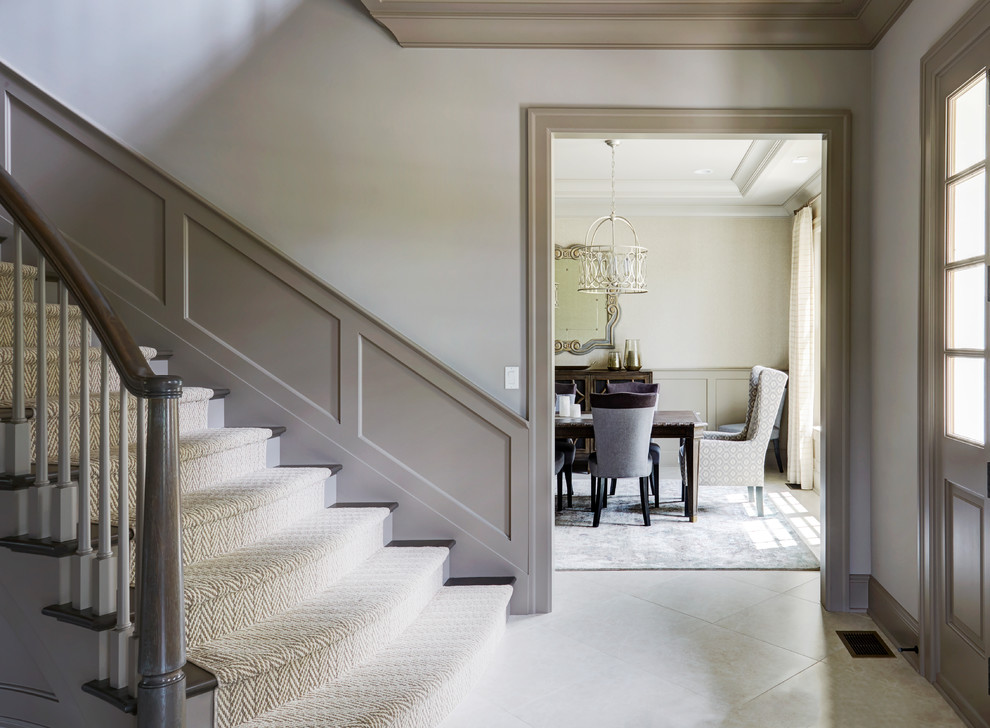 Example of a mid-sized transitional ceramic tile and gray floor front door design with white walls and a gray front door