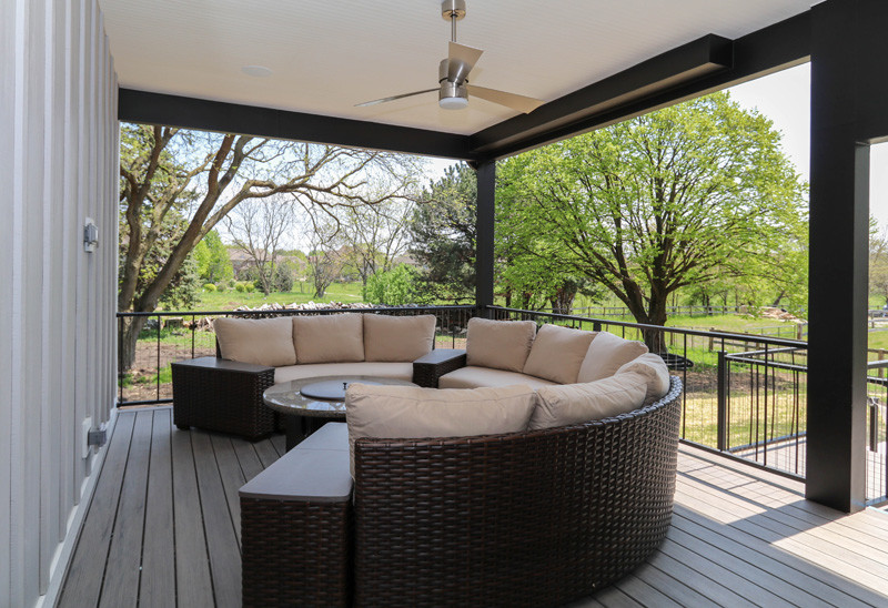 Inspiration for a large transitional backyard screened-in verandah in Chicago with a roof extension.