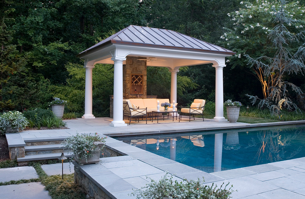 This is an example of a large traditional backyard rectangular lap pool in DC Metro with concrete pavers.