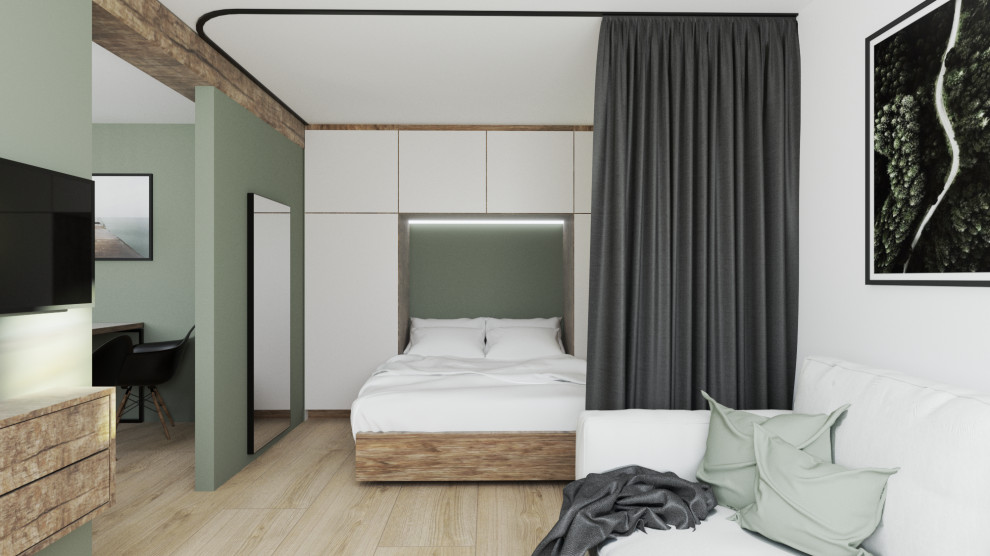 Foto de habitación de invitados rural pequeña con paredes verdes, suelo laminado y suelo marrón