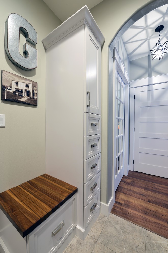 Entryway - mid-sized rustic linoleum floor entryway idea with beige walls and a white front door