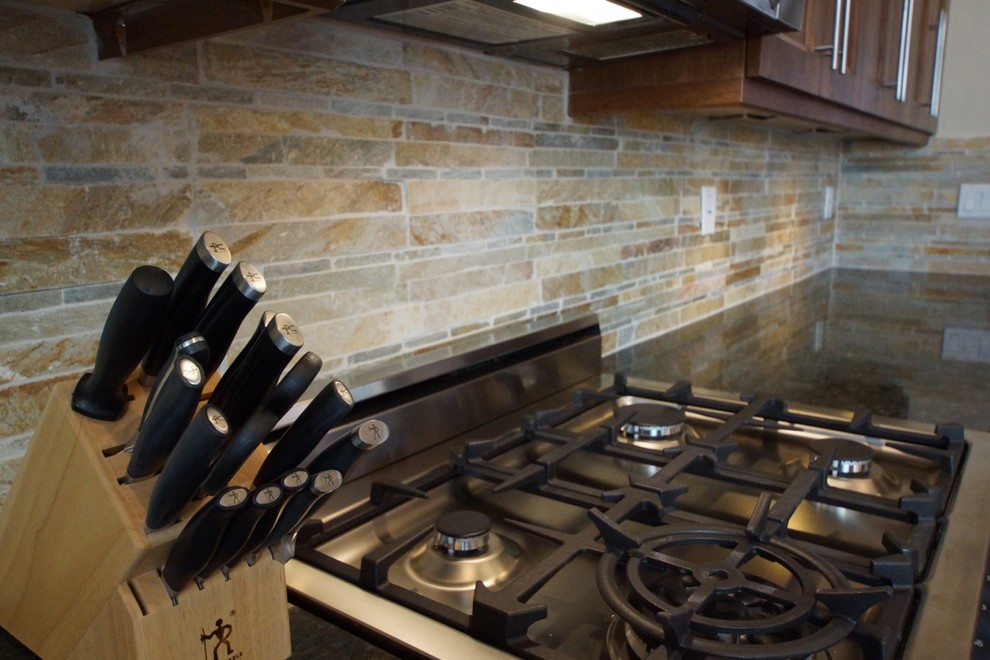 Example of a mid-sized transitional galley medium tone wood floor eat-in kitchen design in Phoenix with an undermount sink, shaker cabinets, medium tone wood cabinets, granite countertops, beige backsplash, stone tile backsplash, stainless steel appliances and an island