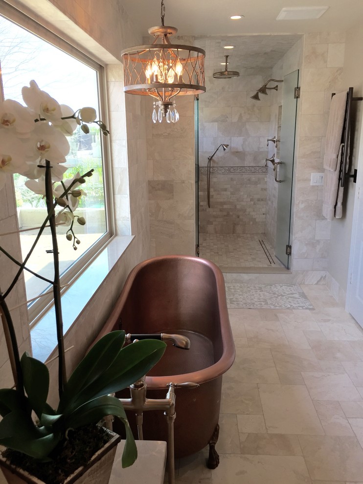 Photo of a large mediterranean master bathroom in Phoenix with recessed-panel cabinets, white cabinets, a claw-foot tub, an alcove shower, gray tile, marble, beige walls, a trough sink, marble benchtops, beige floor, a hinged shower door and brown benchtops.