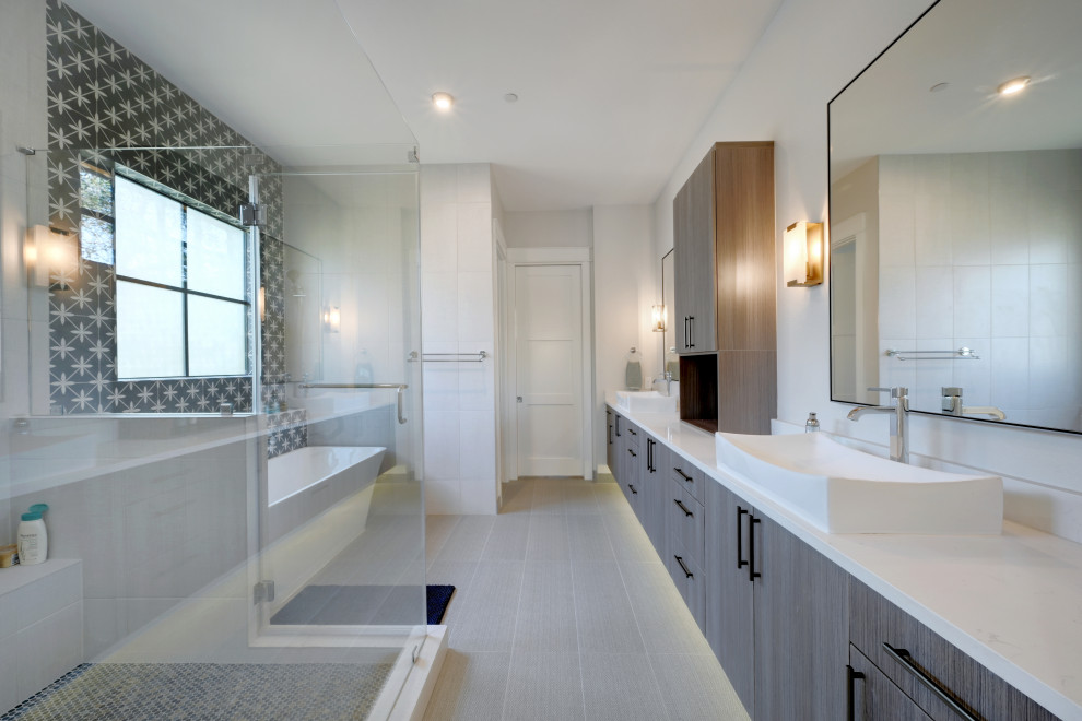 Design ideas for a contemporary master bathroom in Austin with flat-panel cabinets, medium wood cabinets, a freestanding tub, black and white tile, a vessel sink, grey floor, a hinged shower door, white benchtops, a shower seat, an enclosed toilet, a double vanity and a built-in vanity.