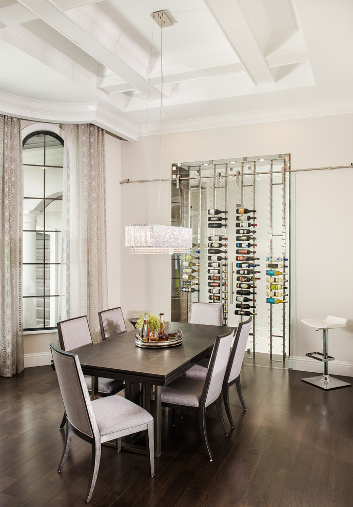 Mediterranean dining room in Orlando with brown floor, beige walls and dark hardwood floors.