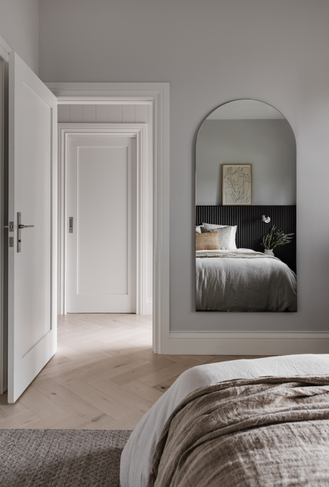 Design ideas for a contemporary master bedroom in Sydney with grey walls and light hardwood floors.