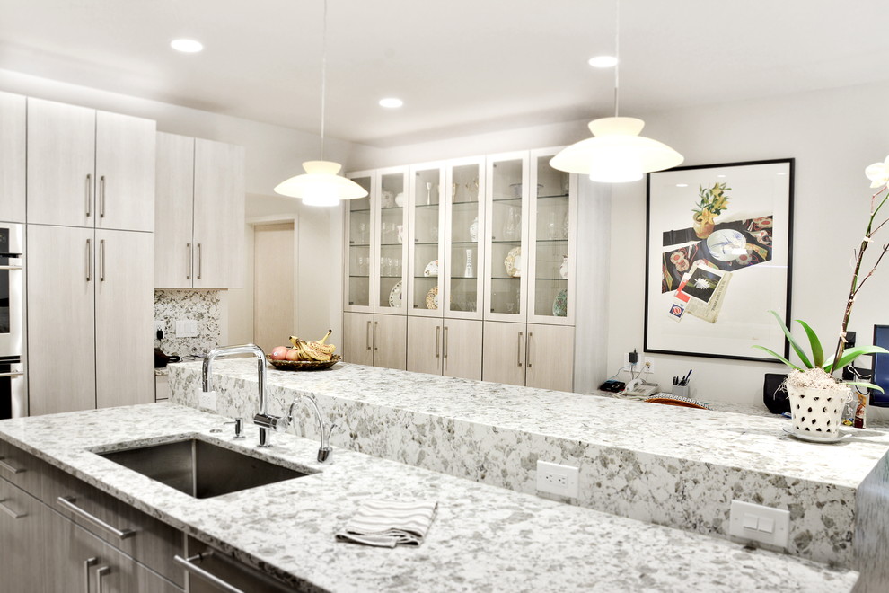 Inspiration for a kitchen in Cleveland with flat-panel cabinets, grey cabinets and stainless steel appliances.