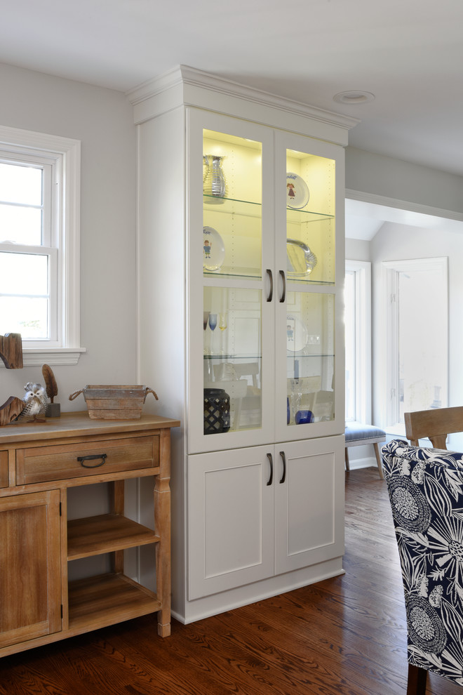 Inspiration for a transitional l-shaped medium tone wood floor eat-in kitchen remodel in Orange County with a double-bowl sink, shaker cabinets, white cabinets, marble countertops, gray backsplash, glass tile backsplash, stainless steel appliances and an island