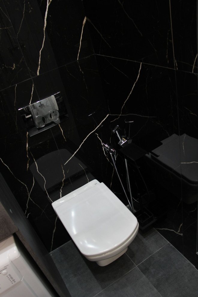Inspiration för ett mellanstort funkis grå grått badrum med dusch, med släta luckor, skåp i mörkt trä, en hörndusch, en vägghängd toalettstol, svart och vit kakel, porslinskakel, klinkergolv i porslin, ett nedsänkt handfat, bänkskiva i akrylsten, grått golv och dusch med skjutdörr