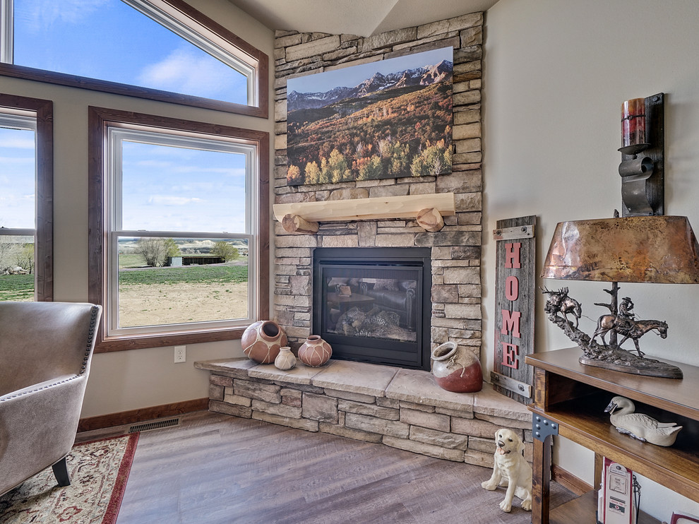 Photo of a mid-sized country open concept living room in Minneapolis with linoleum floors, a corner fireplace, a stone fireplace surround and brown floor.