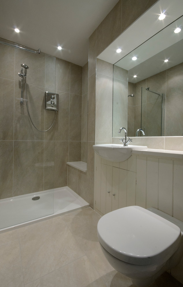 This is an example of a mid-sized country 3/4 bathroom in Dublin with an integrated sink, furniture-like cabinets, light wood cabinets, tile benchtops, a double shower, a wall-mount toilet, brown tile, porcelain tile, brown walls and porcelain floors.