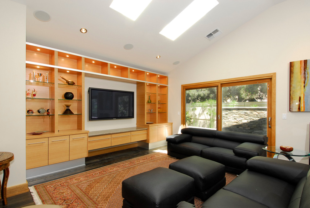 Inspiration for a mid-sized contemporary open concept family room in Orange County with white walls, dark hardwood floors, a standard fireplace, a tile fireplace surround and a wall-mounted tv.