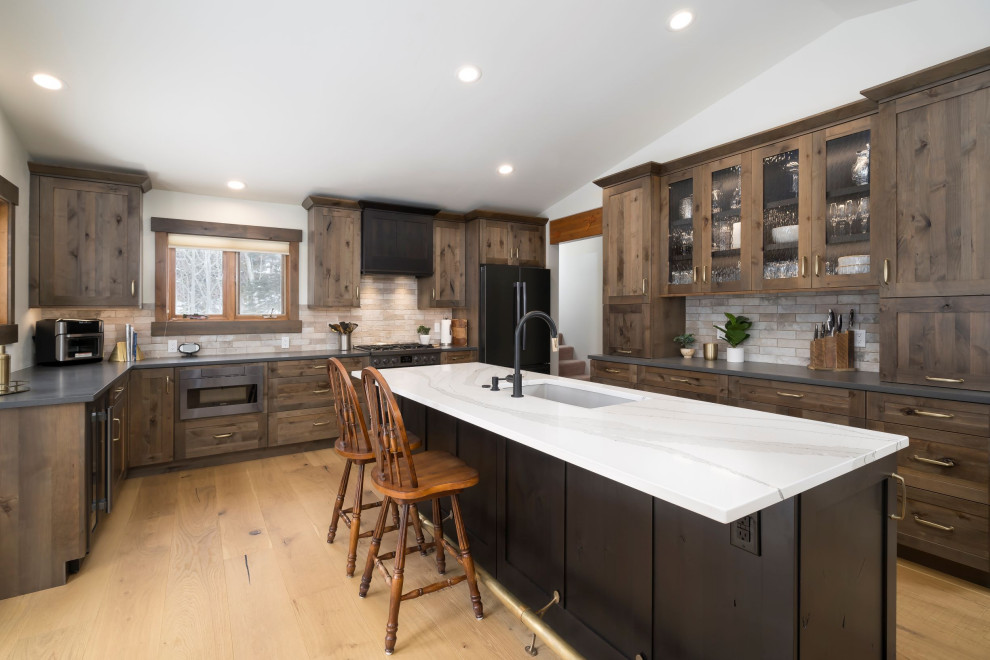 Example of a mid-sized trendy l-shaped open concept kitchen design in Denver with shaker cabinets, medium tone wood cabinets, quartz countertops, gray backsplash, an island and multicolored countertops
