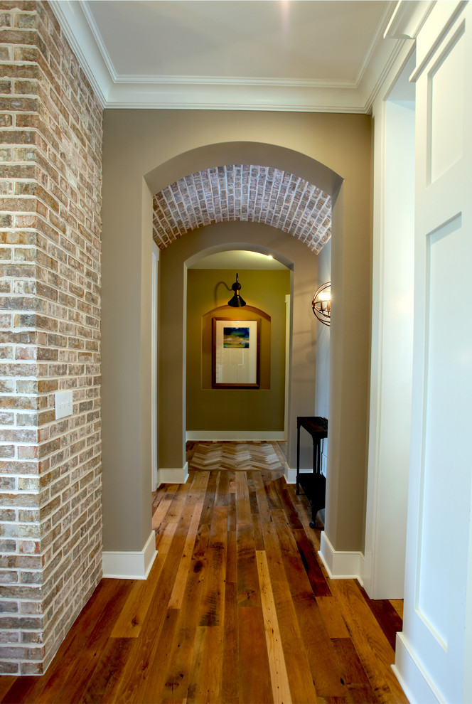 Hallway - traditional brick wall hallway idea in Columbus with gray walls