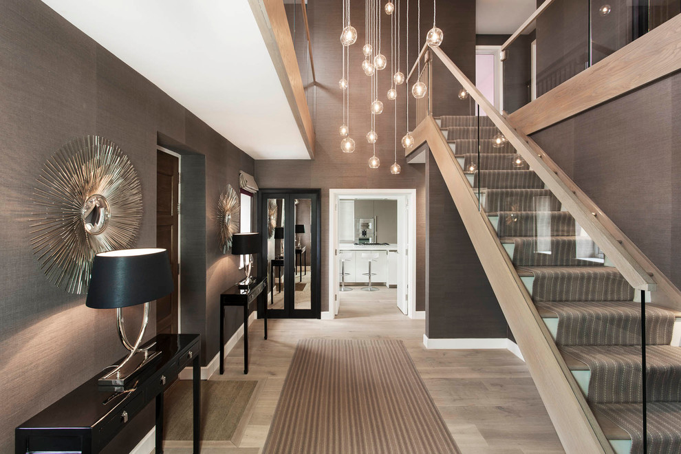 Inspiration for a mid-sized contemporary hallway in London with brown walls and light hardwood floors.