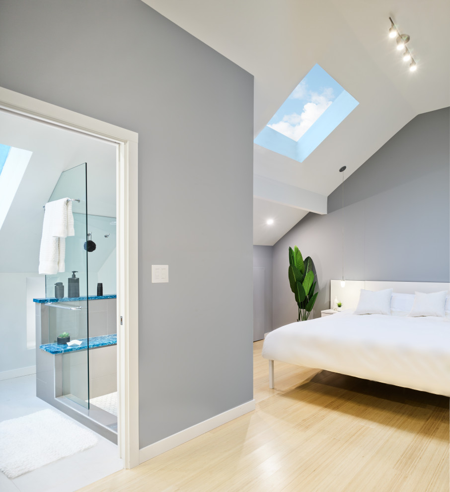 Design ideas for a small modern bedroom in Vancouver with white walls, bamboo floors, beige floor and vaulted.