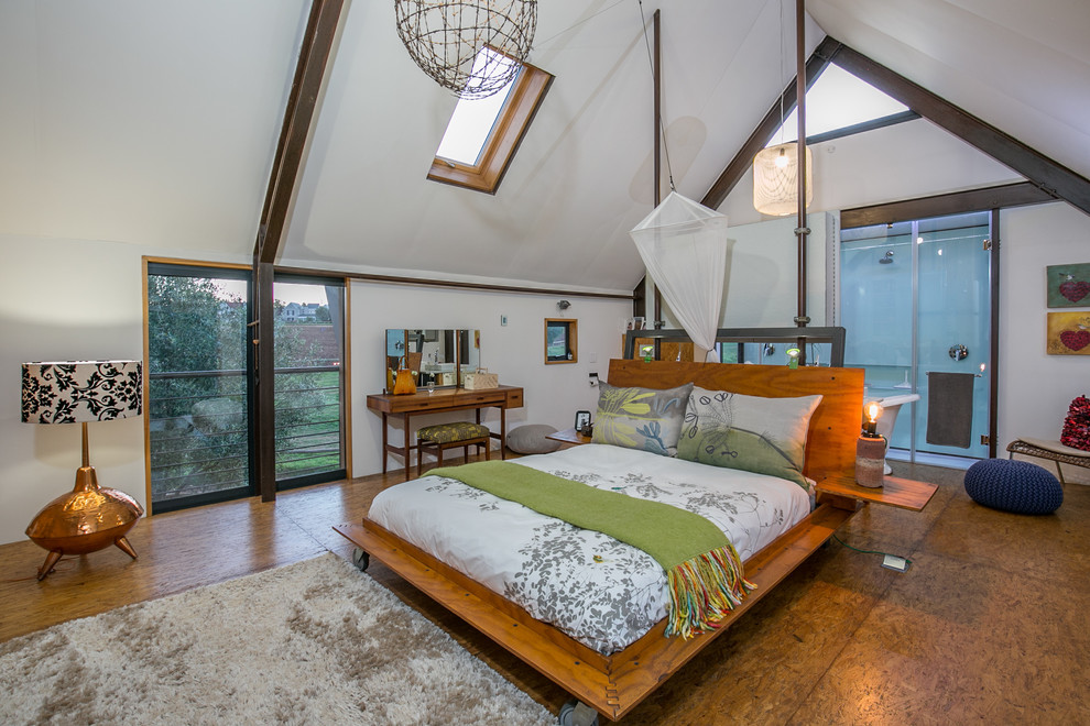 Country master bedroom in Other with white walls, plywood floors, no fireplace and brown floor.