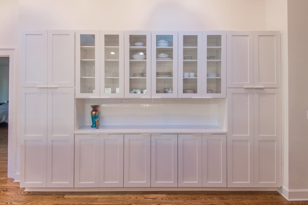 Inspiration for a mid-sized transitional single-wall light wood floor open concept kitchen remodel in Atlanta with a double-bowl sink, recessed-panel cabinets, white cabinets, marble countertops, white backsplash, subway tile backsplash, stainless steel appliances and an island
