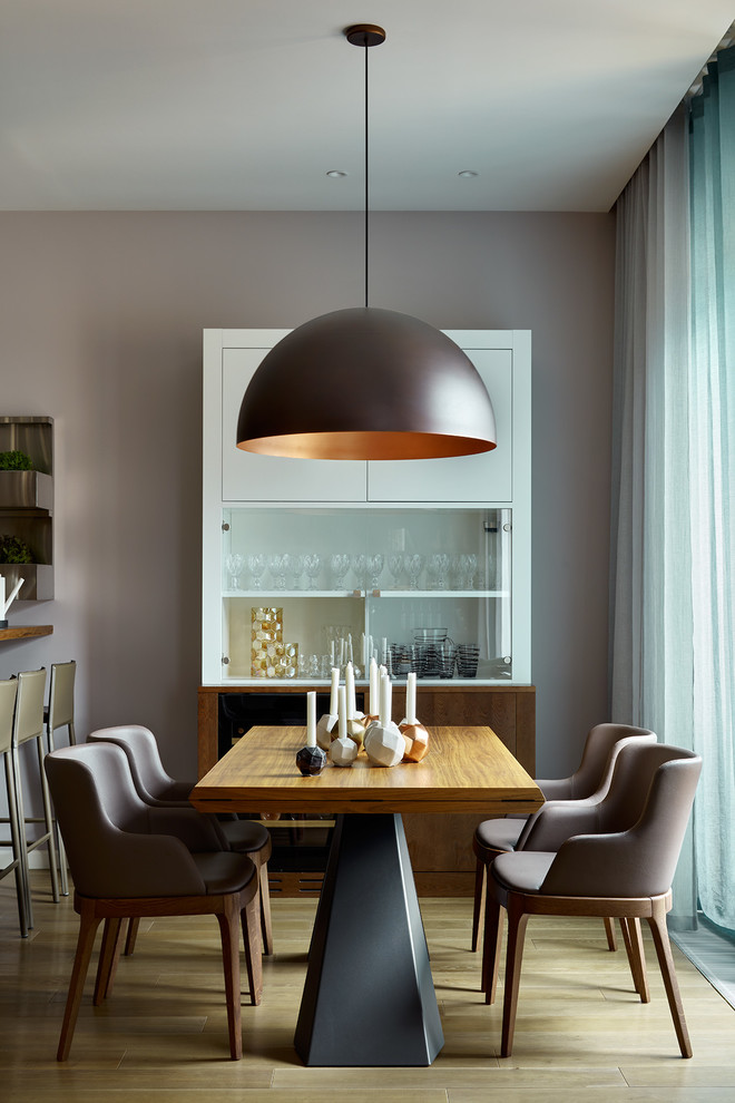 Photo of a mid-sized contemporary dining room in Moscow with grey walls, medium hardwood floors and no fireplace.