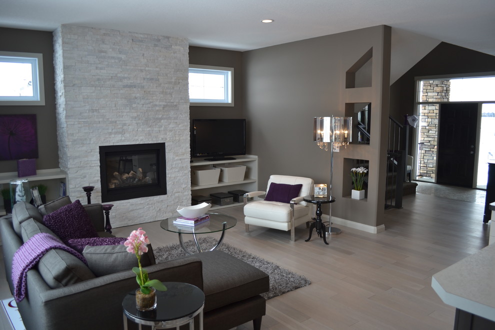 Design ideas for a transitional living room in Calgary with grey walls, a standard fireplace and a freestanding tv.