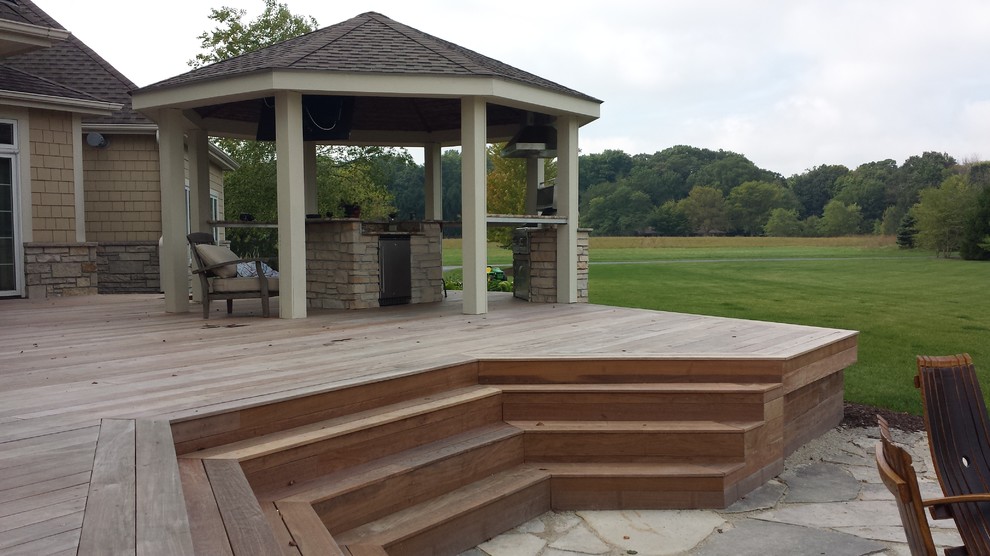 Inspiration for an expansive arts and crafts backyard deck in Milwaukee with an outdoor kitchen and a pergola.
