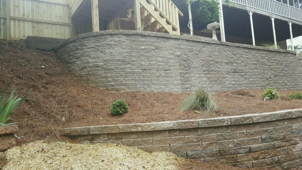 Inspiration for a large backyard partial sun garden in Birmingham with a retaining wall.