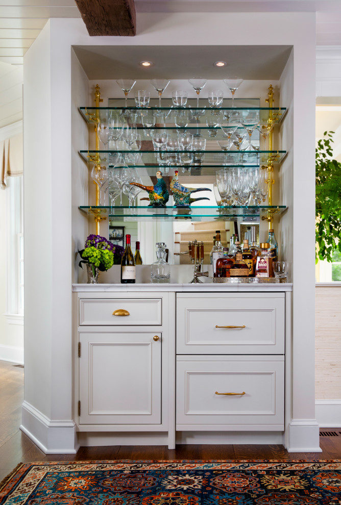Design ideas for a mid-sized traditional single-wall home bar in Philadelphia with beaded inset cabinets, white cabinets, marble benchtops and white benchtop.