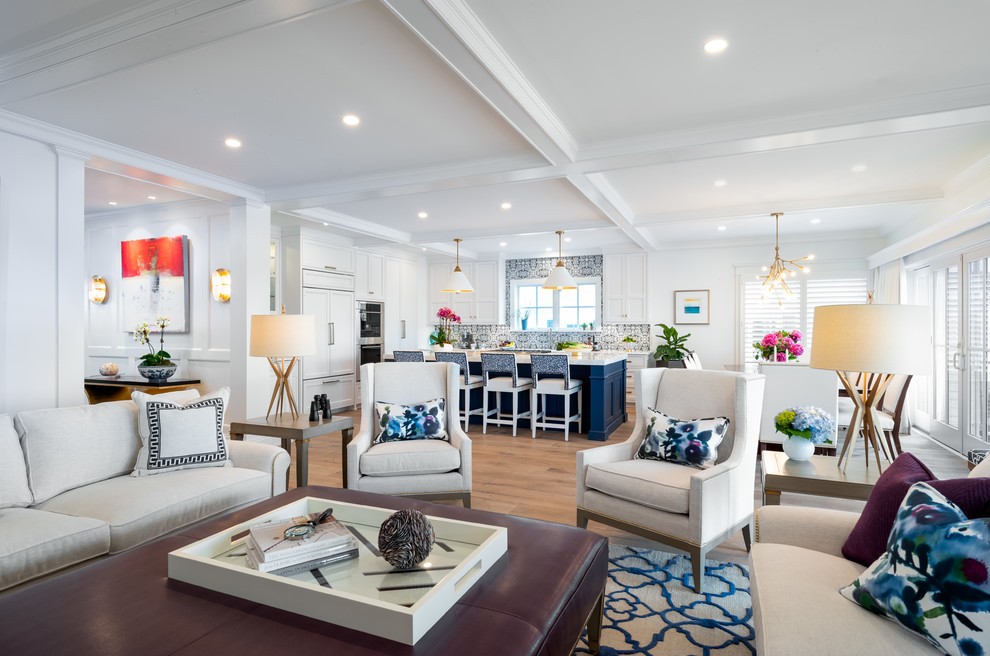 Photo of a large beach style open concept living room in Philadelphia with white walls, medium hardwood floors and grey floor.