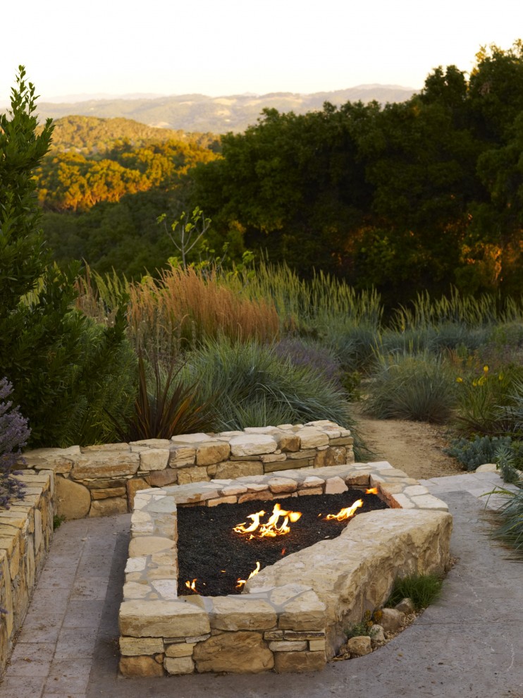 Large contemporary backyard patio in San Luis Obispo with a fire feature and natural stone pavers.