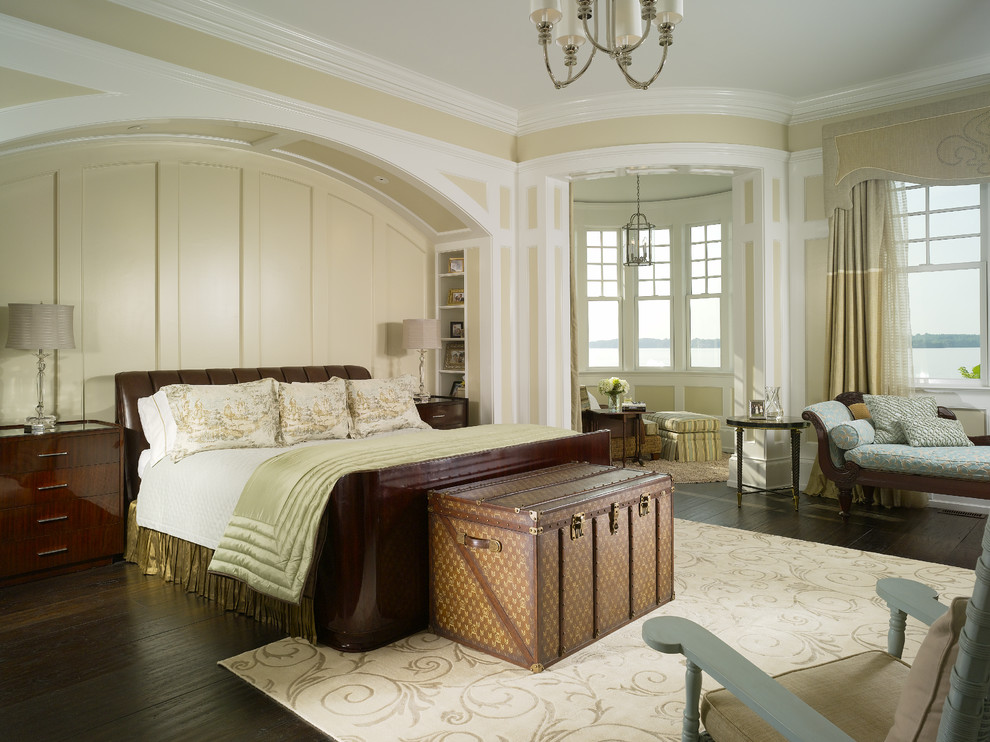 This is an example of a traditional master bedroom in Other with beige walls, dark hardwood floors and no fireplace.
