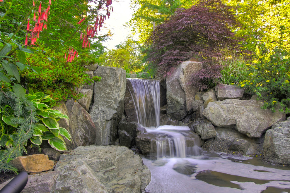 This is an example of a country garden in Portland with with waterfall.