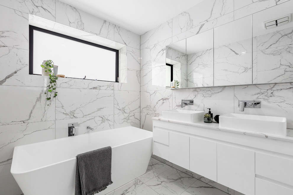 Design ideas for a small contemporary 3/4 bathroom in Melbourne with open cabinets, white cabinets, a freestanding tub, a double shower, a one-piece toilet, white tile, porcelain tile, white walls, porcelain floors, a drop-in sink, solid surface benchtops, white floor, a sliding shower screen and white benchtops.