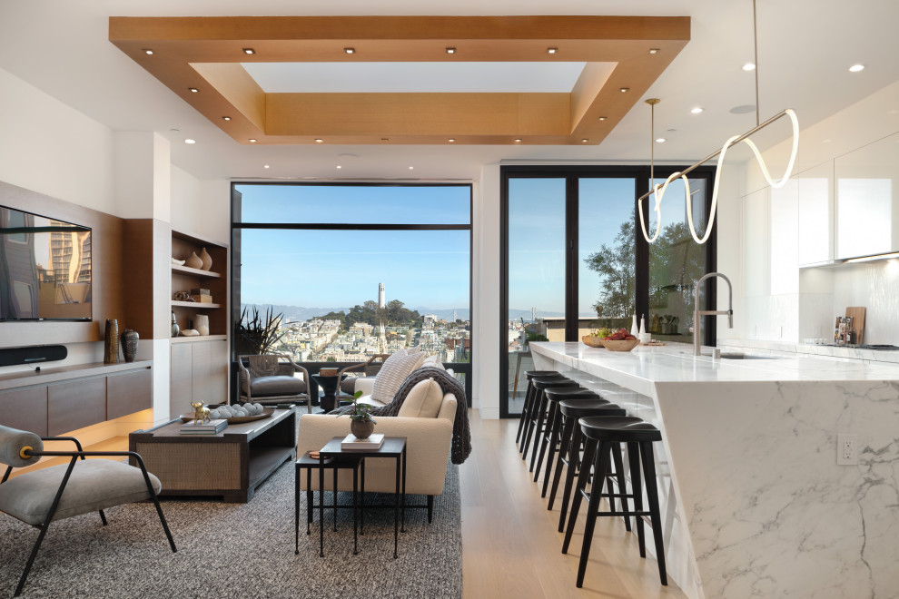 Design ideas for a contemporary open concept living room in San Francisco with white walls, light hardwood floors, beige floor and recessed.