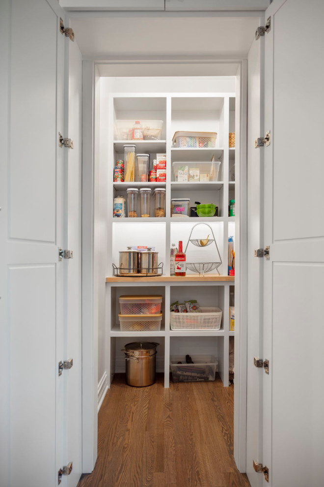 Kitchen - small transitional medium tone wood floor kitchen idea in Chicago with wood countertops and white backsplash