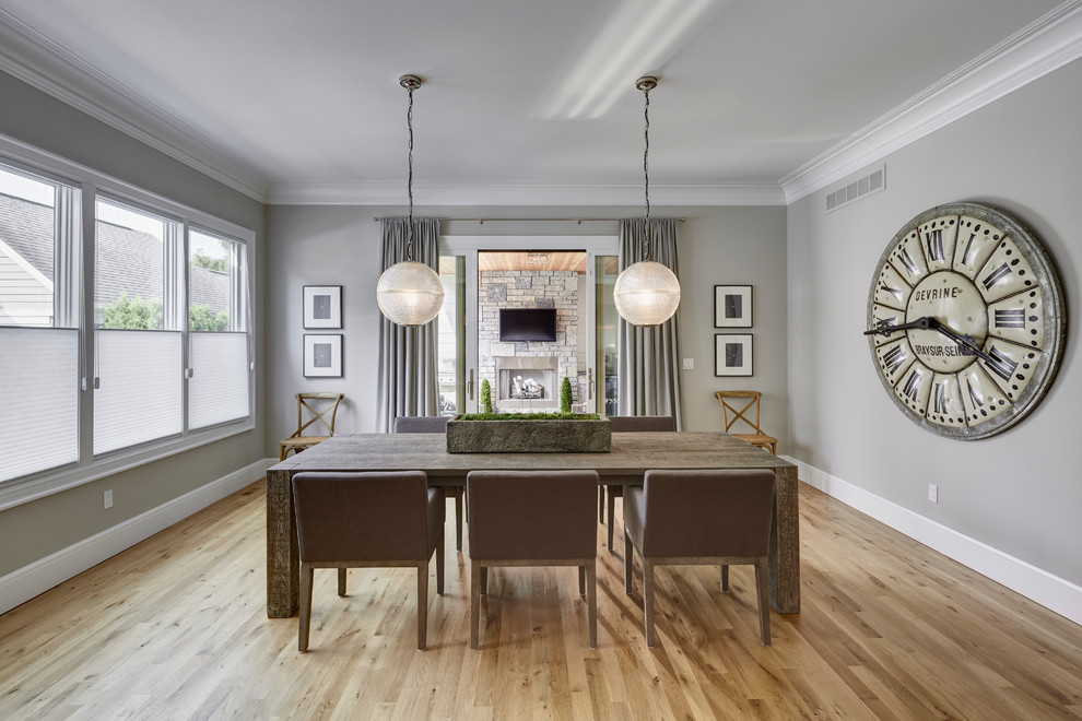 Dining room - large farmhouse light wood floor dining room idea in Detroit with gray walls and no fireplace