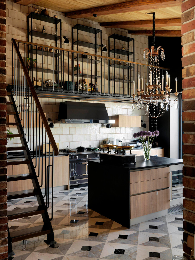 Photo of a mid-sized industrial single-wall eat-in kitchen in Moscow with marble floors, multi-coloured floor, flat-panel cabinets, white splashback, black appliances, with island, black benchtop and light wood cabinets.
