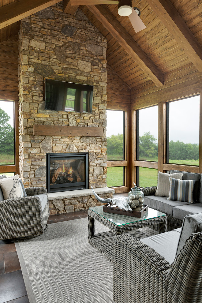 Design ideas for an expansive traditional sunroom in Minneapolis with ceramic floors, a standard fireplace, a stone fireplace surround and a standard ceiling.