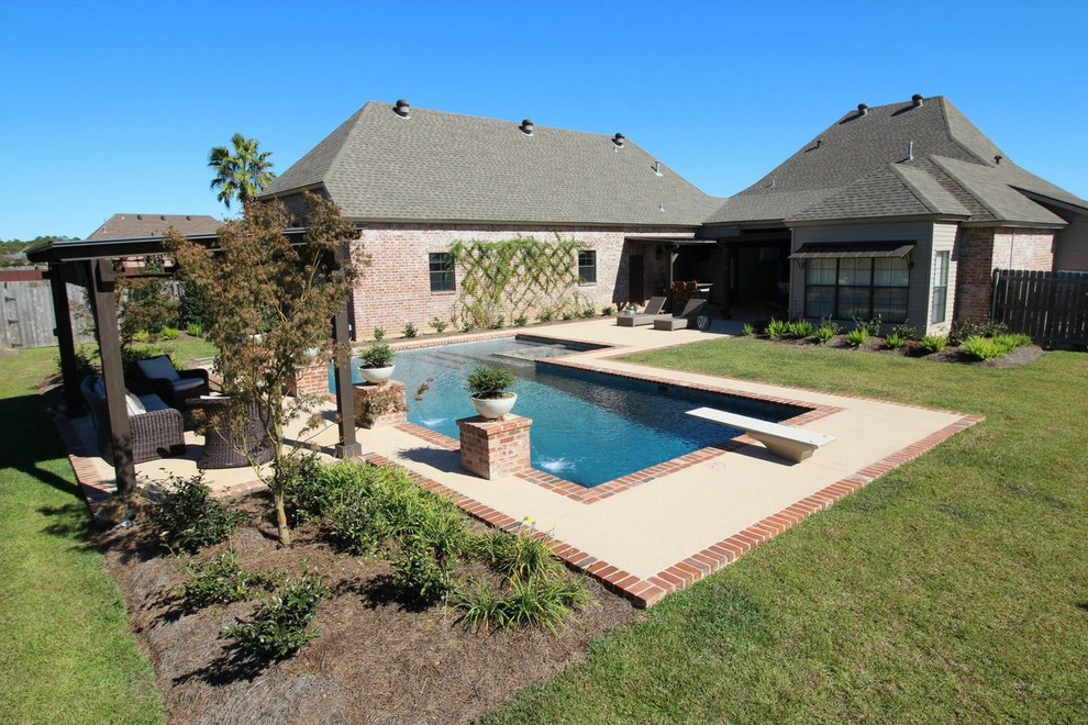 Example of a large transitional backyard concrete and rectangular hot tub design in New Orleans