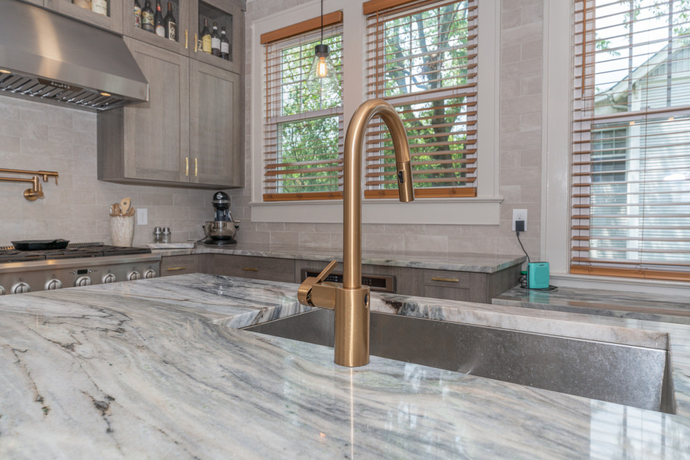 Inspiration for a small transitional u-shaped kitchen remodel in DC Metro with an undermount sink, shaker cabinets, marble countertops, stainless steel appliances and an island