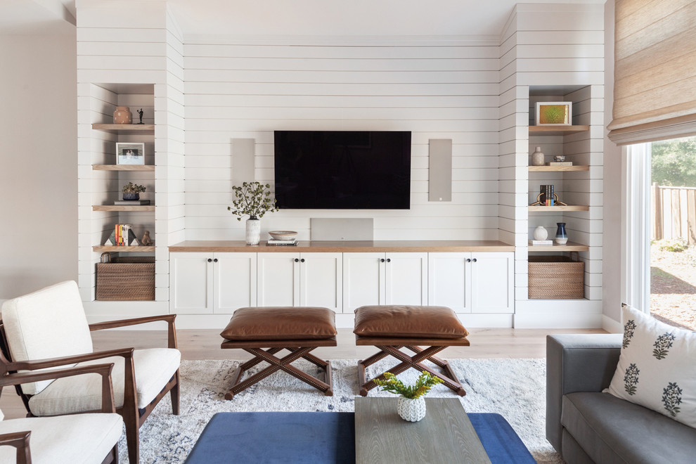 Photo of a beach style open concept family room in San Francisco with white walls, light hardwood floors, no fireplace, a built-in media wall and planked wall panelling.