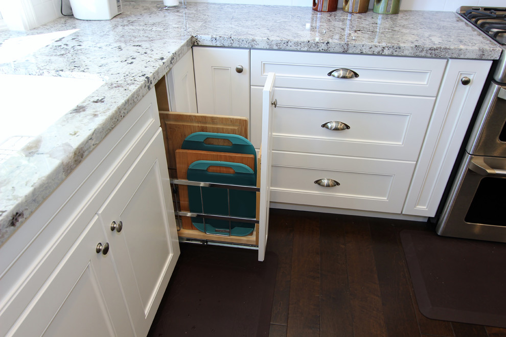 Eat-in kitchen - large transitional l-shaped dark wood floor eat-in kitchen idea in Orange County with a single-bowl sink, recessed-panel cabinets, white cabinets, granite countertops, white backsplash, ceramic backsplash, stainless steel appliances and an island