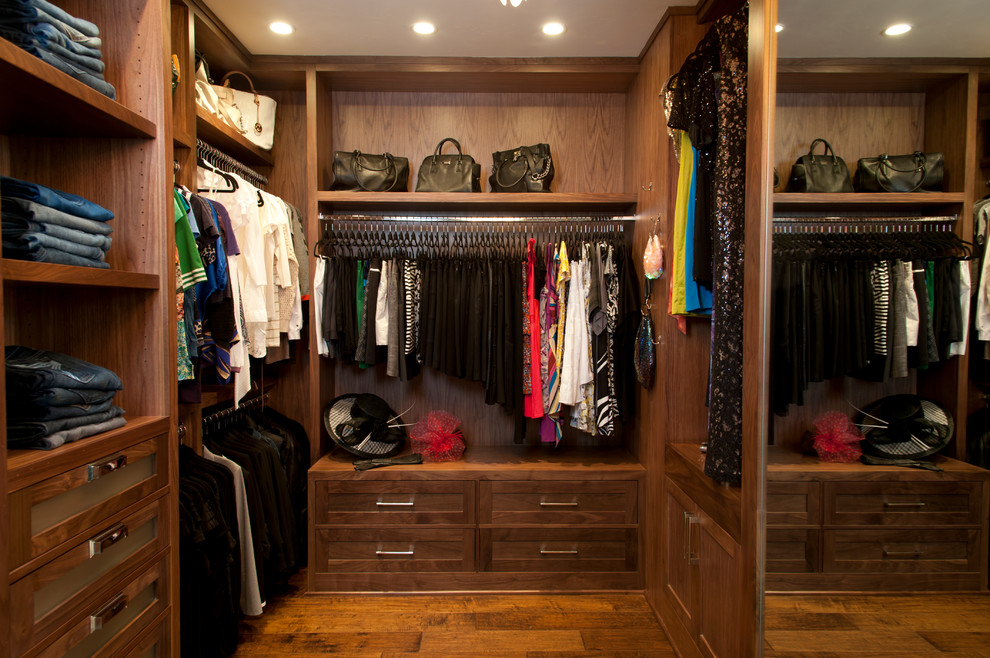 Photo of a large traditional women's walk-in wardrobe in San Diego with recessed-panel cabinets, dark wood cabinets and dark hardwood floors.
